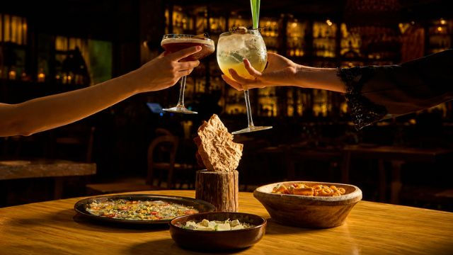 A toast with cocktails and shared dishes at Chambao Polanco restaurant